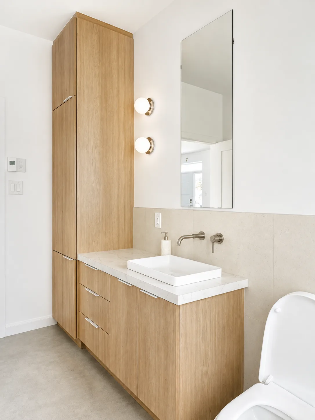Vanité suspendue en bois clair et armoire de salle de bain assortie